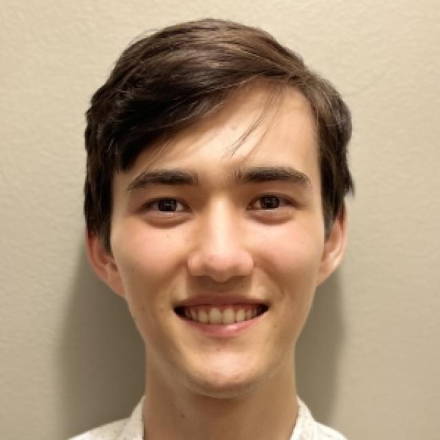photo of a young male with short brown hair, smiling