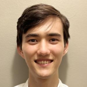 photo of a young male with short brown hair, smiling